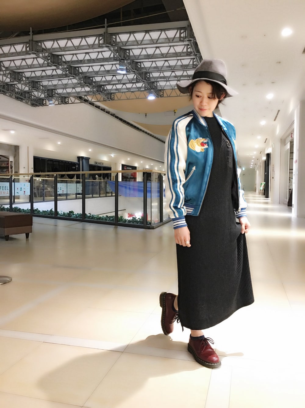 ブラック系のワンピース、ブルー系のブルゾン、グレー系のハットを着用したレディースの冬コーディネートの1枚目の写真