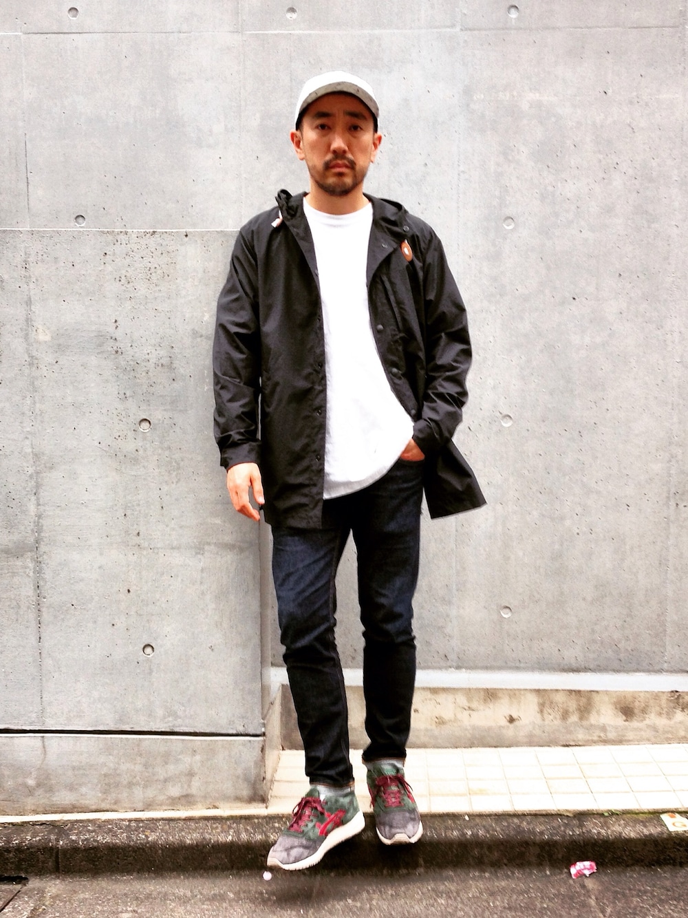 ブラック系のマウンテンパーカー、ブルー系のデニムパンツ、ホワイト系のTシャツ/カットソーを着用したメンズの春コーディネートの1枚目の写真