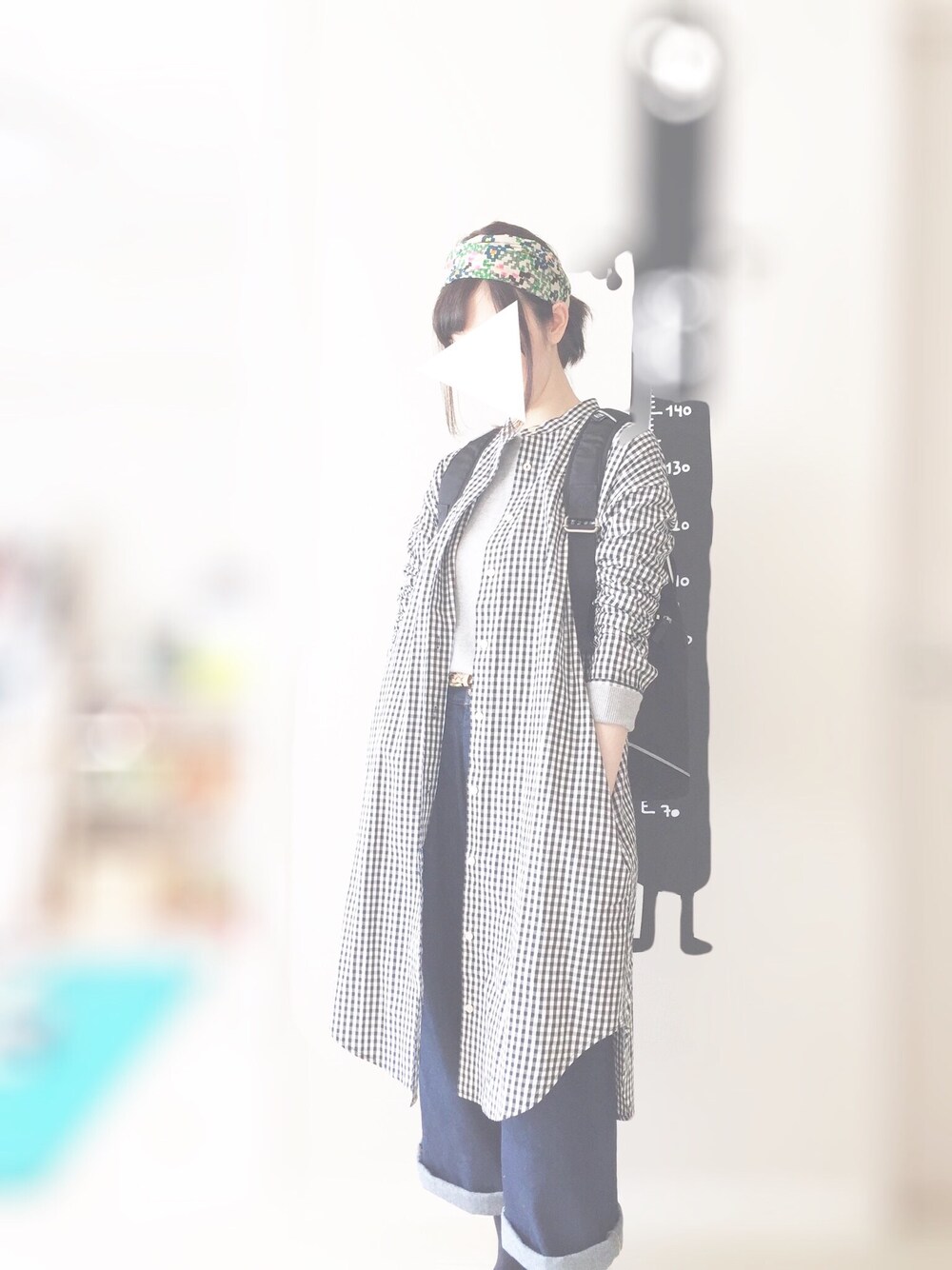 ブラック系のシャツワンピース、ブラック系のバックパック/リュック、ブルー系のデニムパンツを着用したレディースの春コーディネートの1枚目の写真