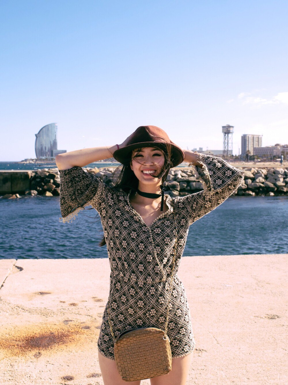 ブラック系のシャツワンピース、ブラウン系のハットを着用したレディースの夏コーディネートの1枚目の写真