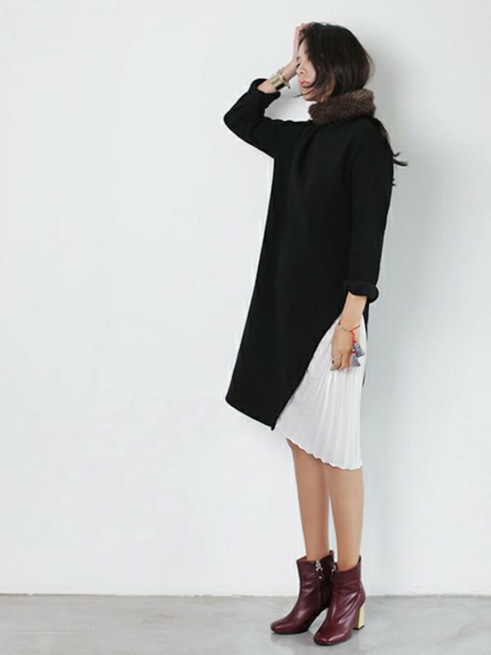 レッド系のブーツ、ブラック系のワンピース、ブラウン系のネックウォーマー/スヌードを着用したレディースの秋コーディネートの1枚目の写真