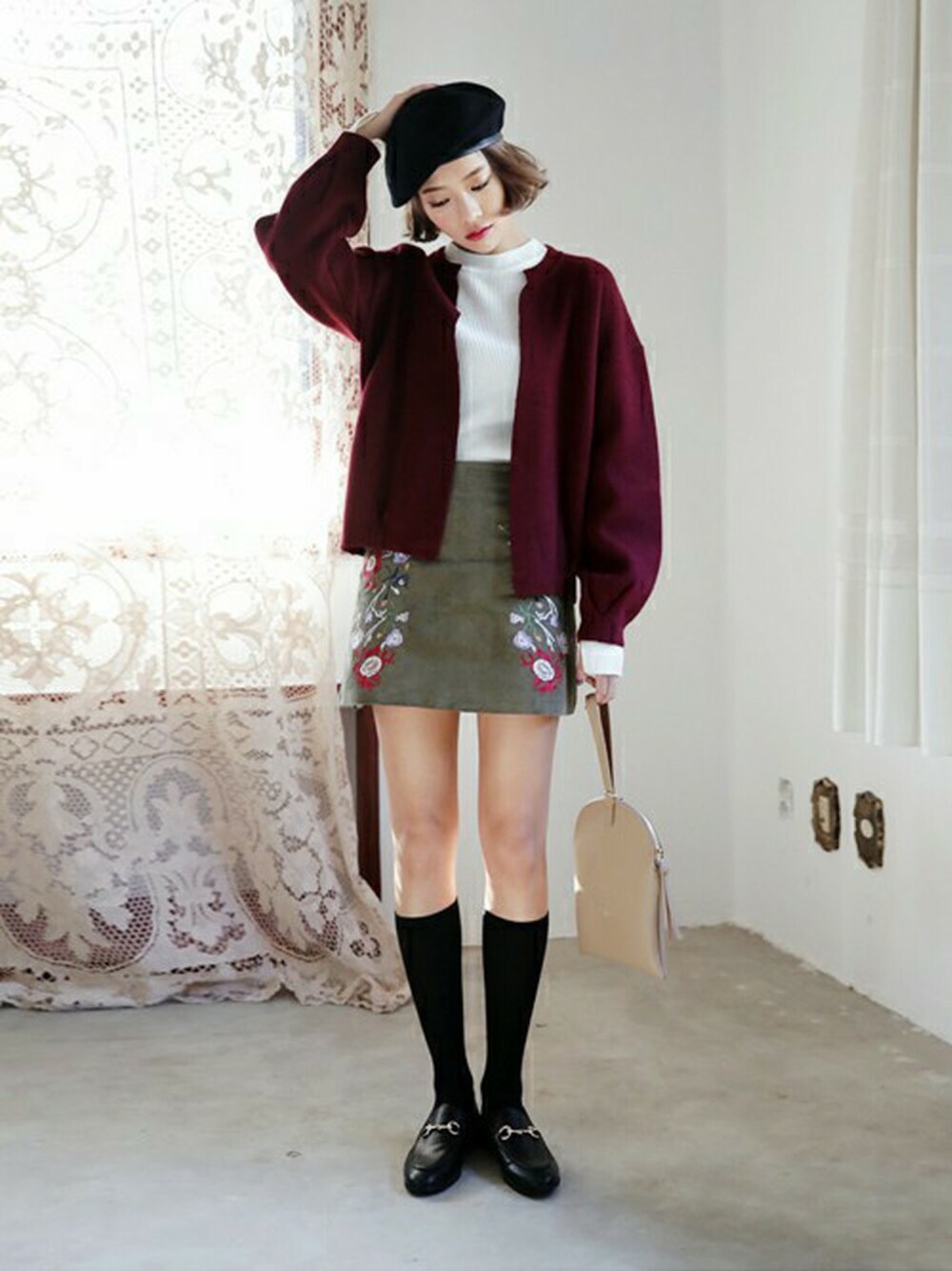 グリーン系のスカート、レッド系のカーディガン/ボレロ、ホワイト系のTシャツ/カットソーを着用したレディースの秋コーディネートの1枚目の写真