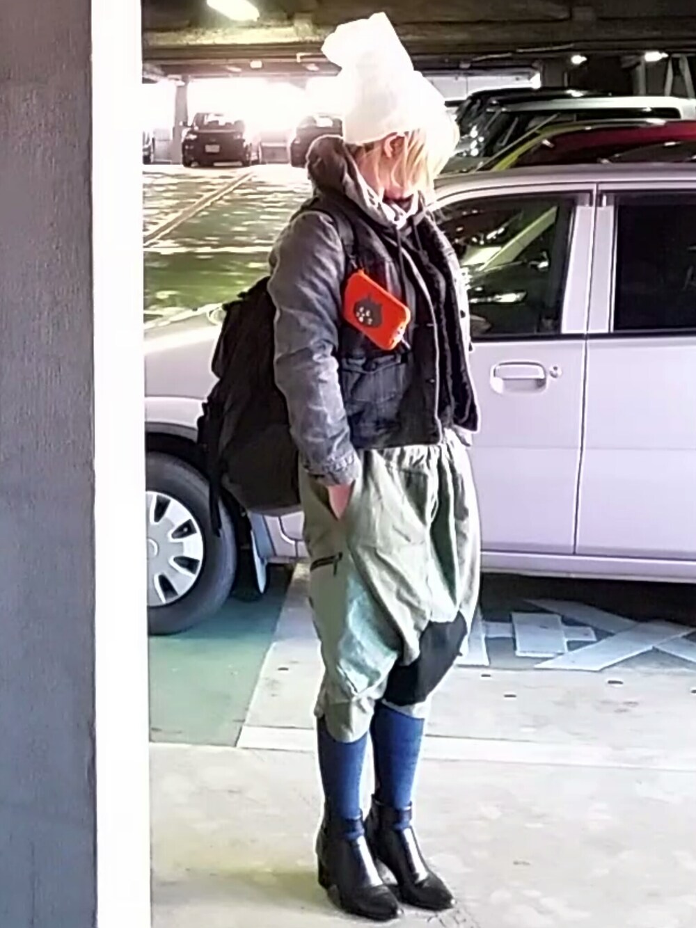 グレー系のパーカー、ブラック系のバックパック/リュック、ブラック系のブーティを着用したレディースの秋コーディネートの1枚目の写真