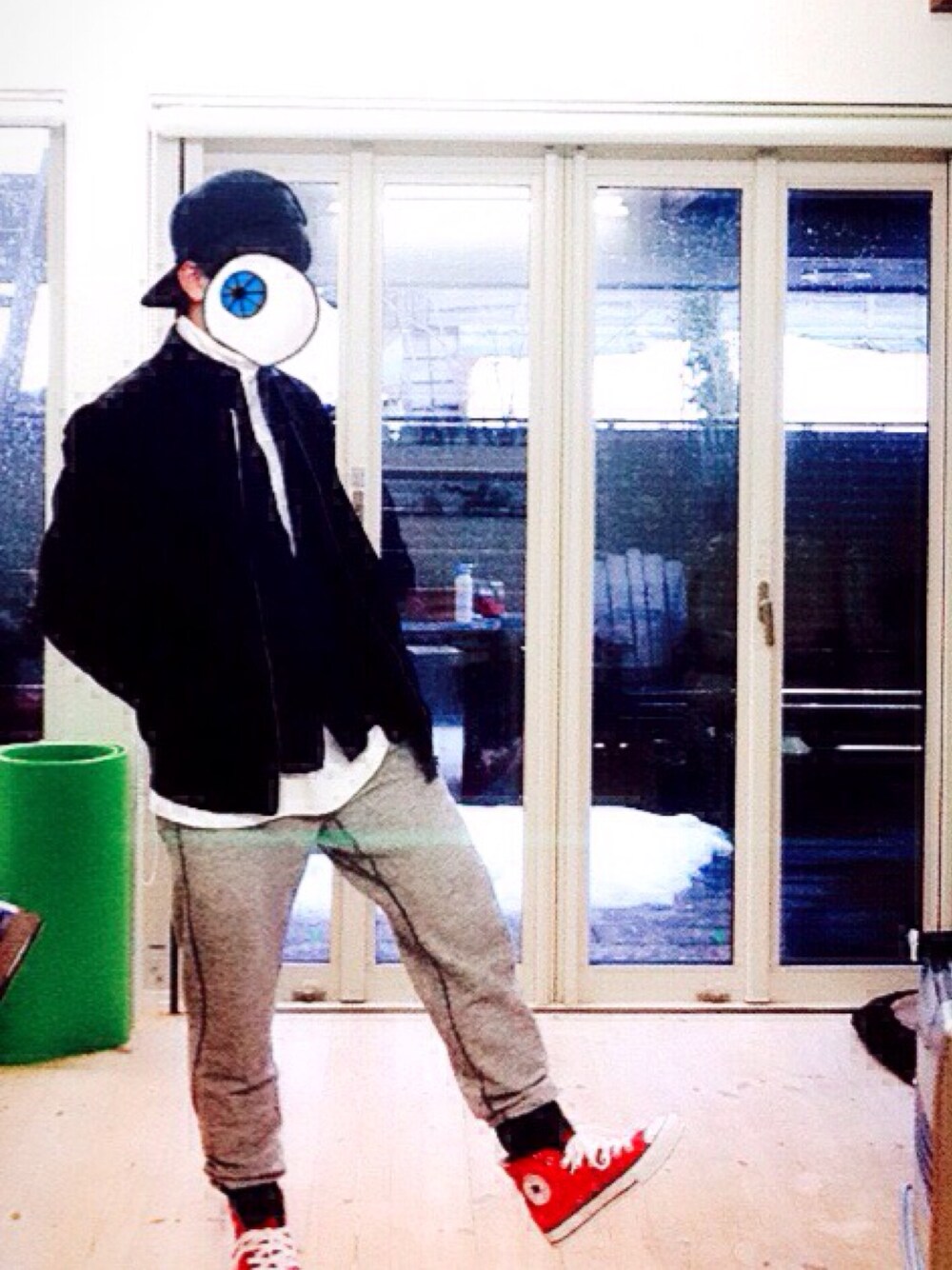 グレー系のスラックス、レッド系のスニーカー、ホワイト系のスウェットを着用したメンズの冬コーディネートの1枚目の写真