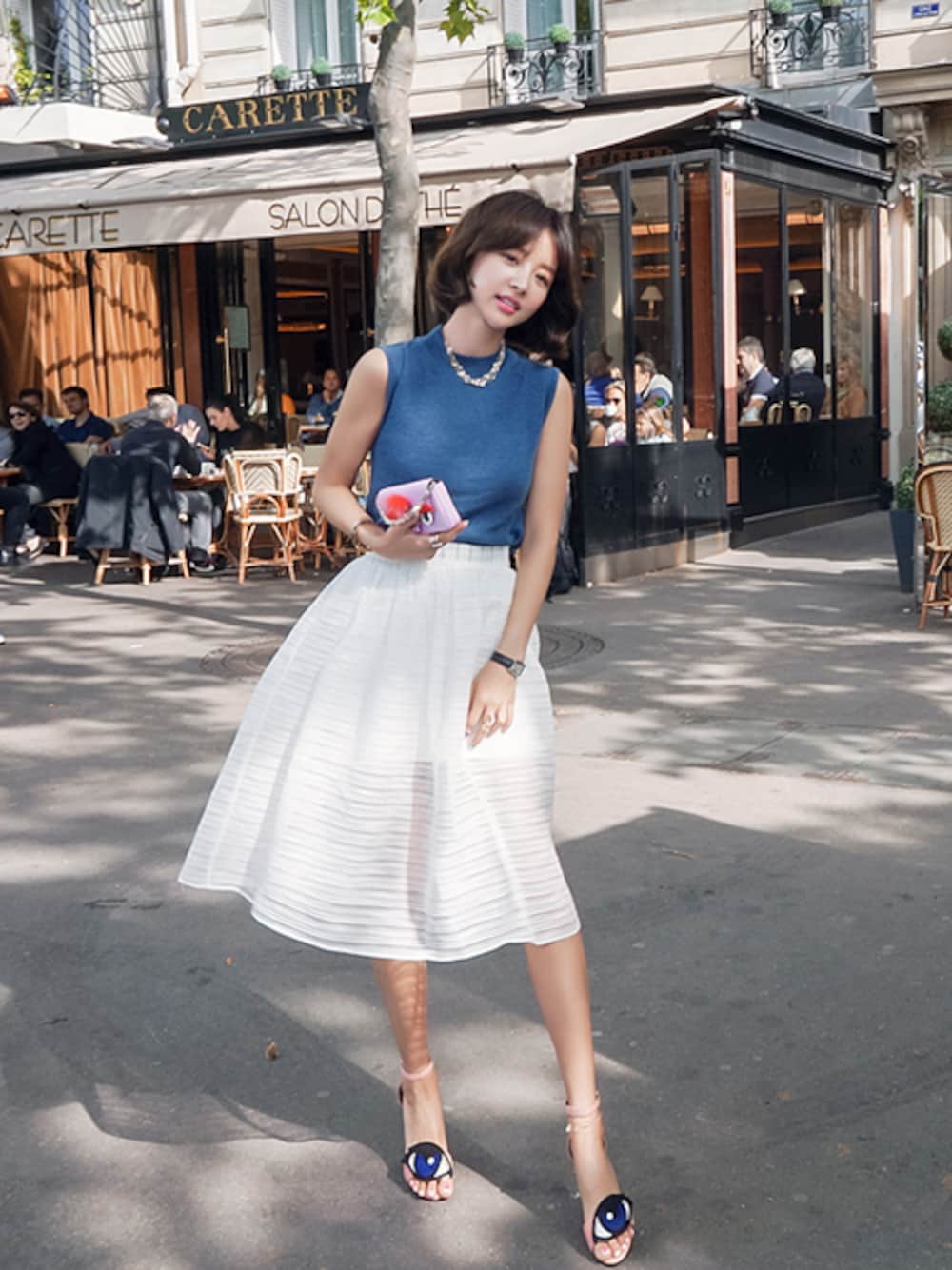 ホワイト系のスカート、ブルー系のTシャツ/カットソー、ブラック系のサンダルを着用したレディースの春コーディネートの1枚目の写真