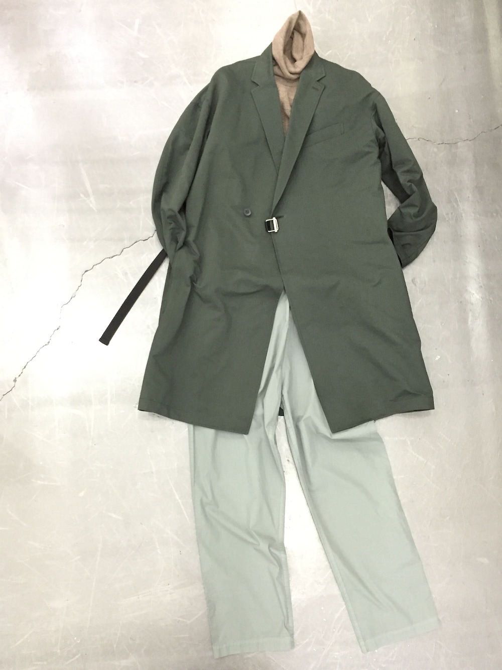 ブラウン系のTシャツ/カットソー、グリーン系のチェスターコート、グリーン系のチノパンツを着用したメンズの秋コーディネートの1枚目の写真