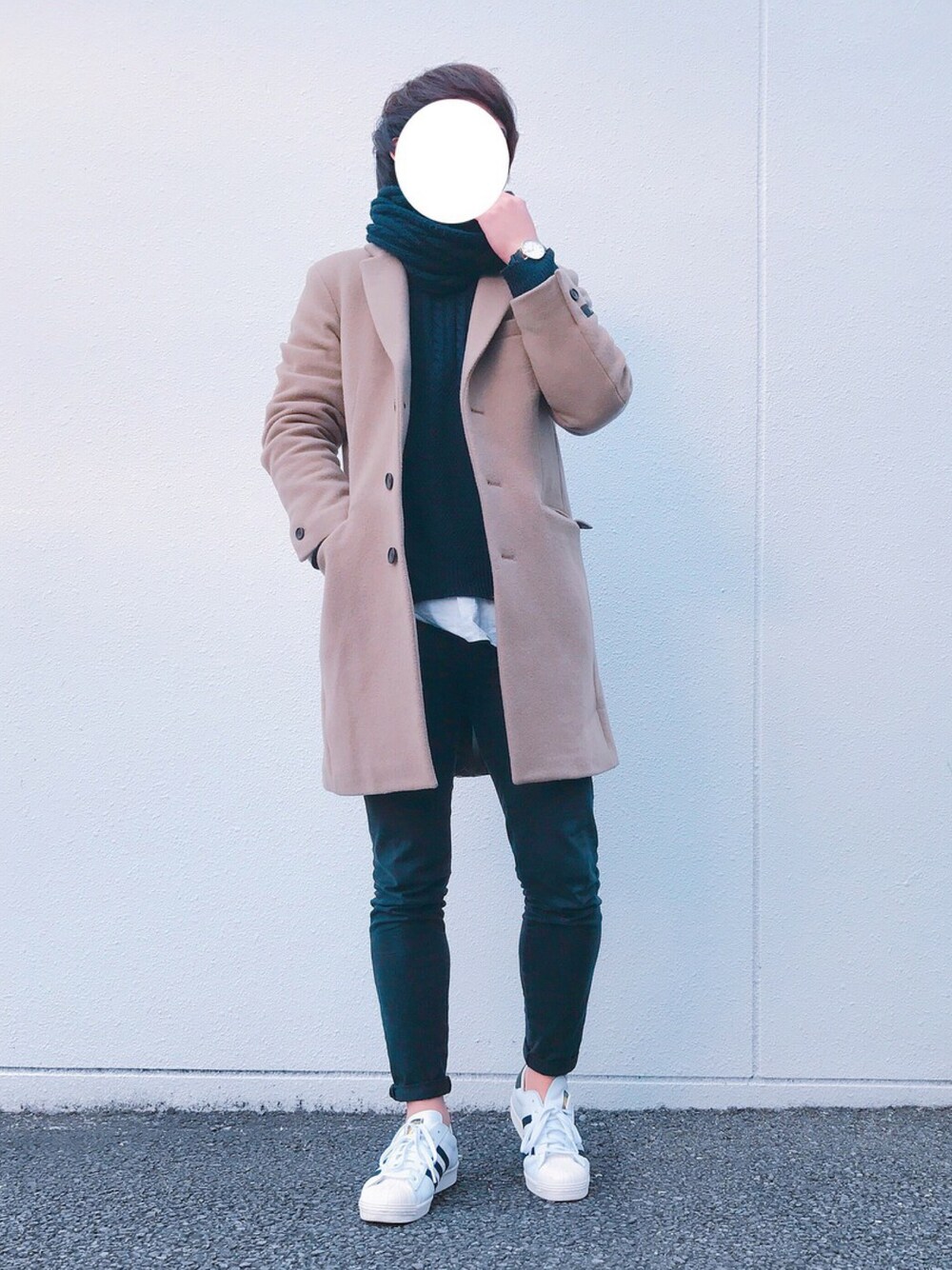 ホワイト系のスニーカー、ブラック系のチノパンツ、ベージュ系のチェスターコートを着用したメンズの冬コーディネートの1枚目の写真