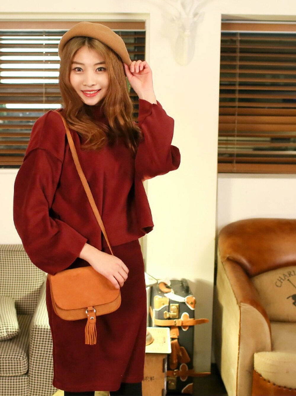 レッド系のニット/セーター、ブラウン系のショルダーバッグ、ブラウン系のハンチング/ベレー帽を着用したレディースの秋コーディネートの1枚目の写真