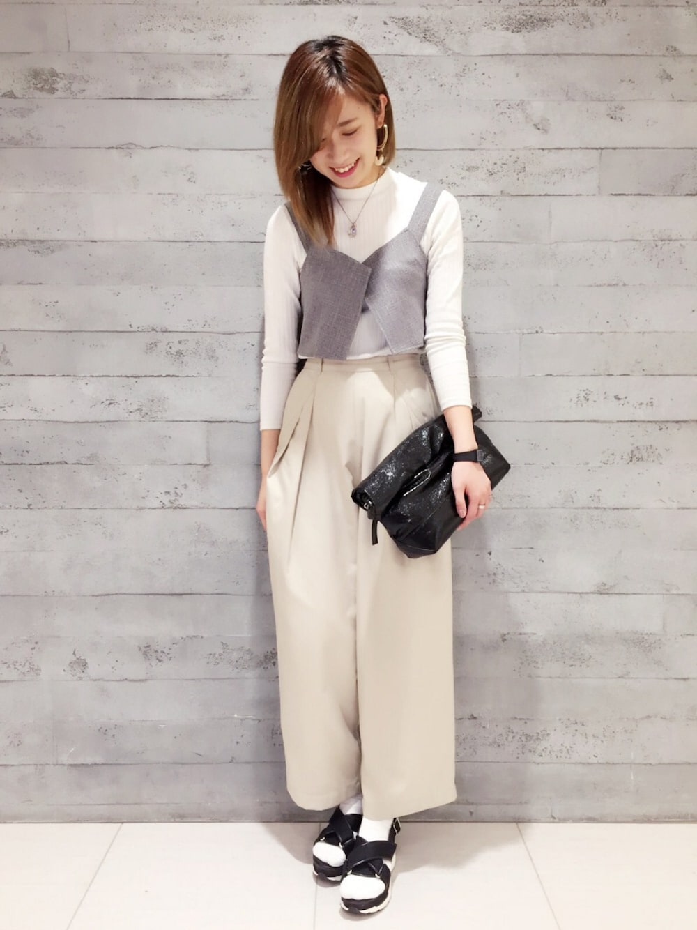 グレー系のキャミソール、ホワイト系のTシャツ/カットソー、ブラック系のサンダルを着用したレディースの春コーディネートの1枚目の写真