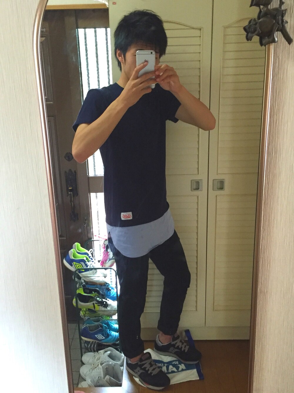 ブルー系のTシャツ/カットソー、ブラック系のデニムパンツ、ブラック系のスニーカーを着用したメンズの秋コーディネートの1枚目の写真