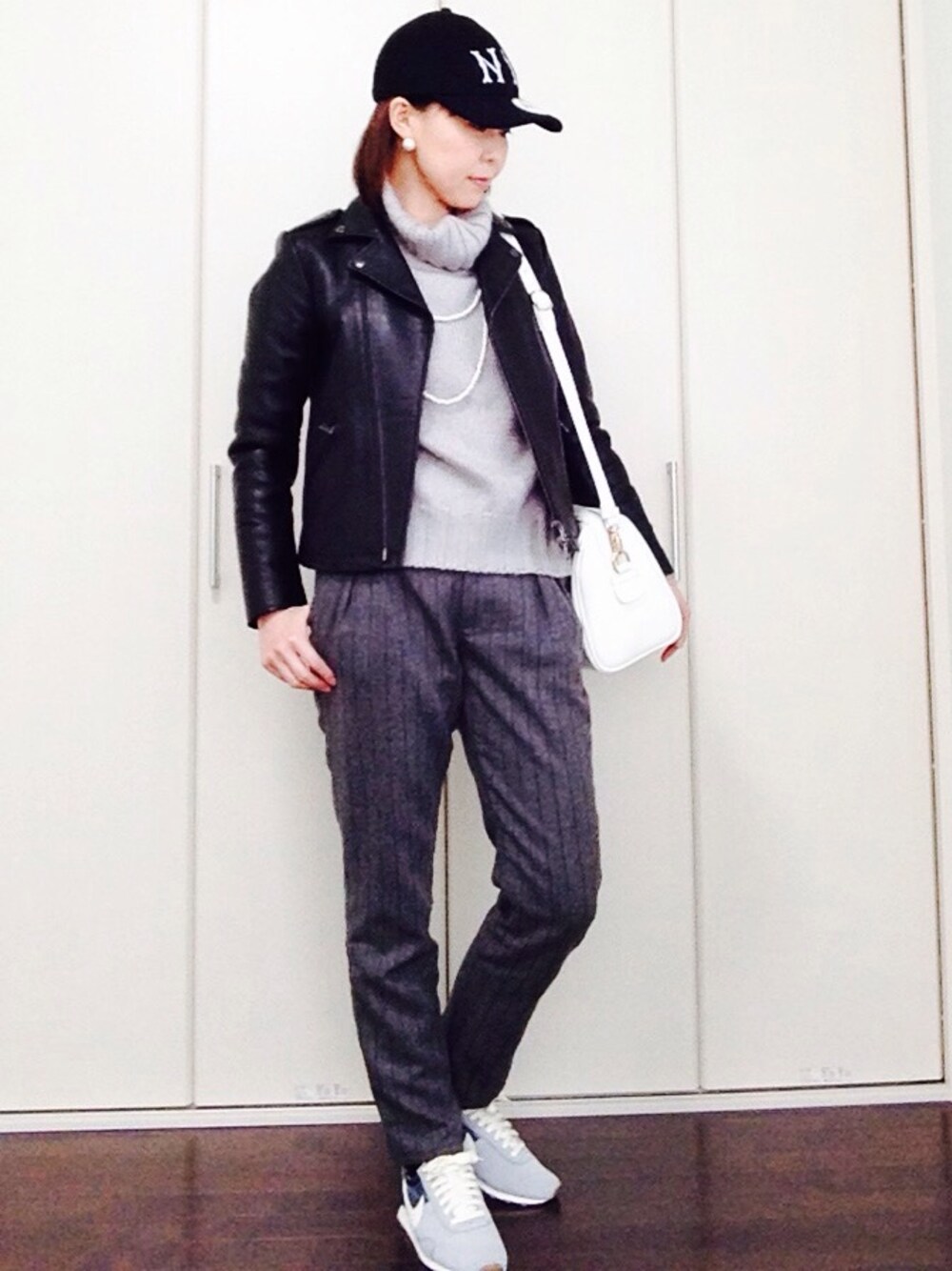 グレー系のニット/セーター、グレー系のその他パンツ、ブラック系のライダースジャケットを着用したレディースの冬コーディネートの1枚目の写真