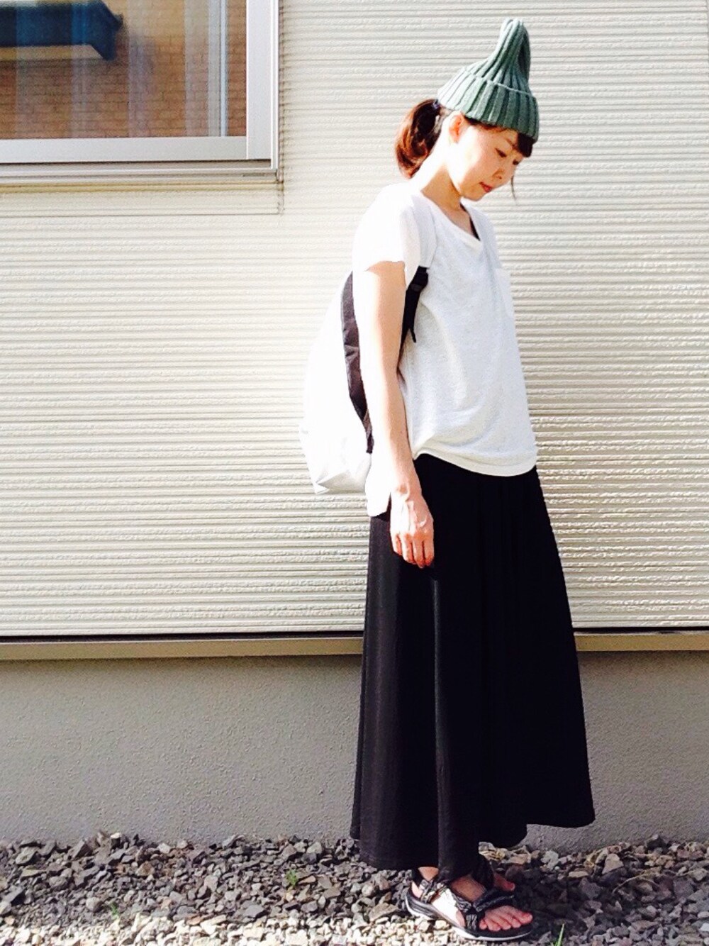 ホワイト系のTシャツ/カットソー、ブラック系のワンピース、グレー系のサンダルを着用したレディースの夏コーディネートの1枚目の写真