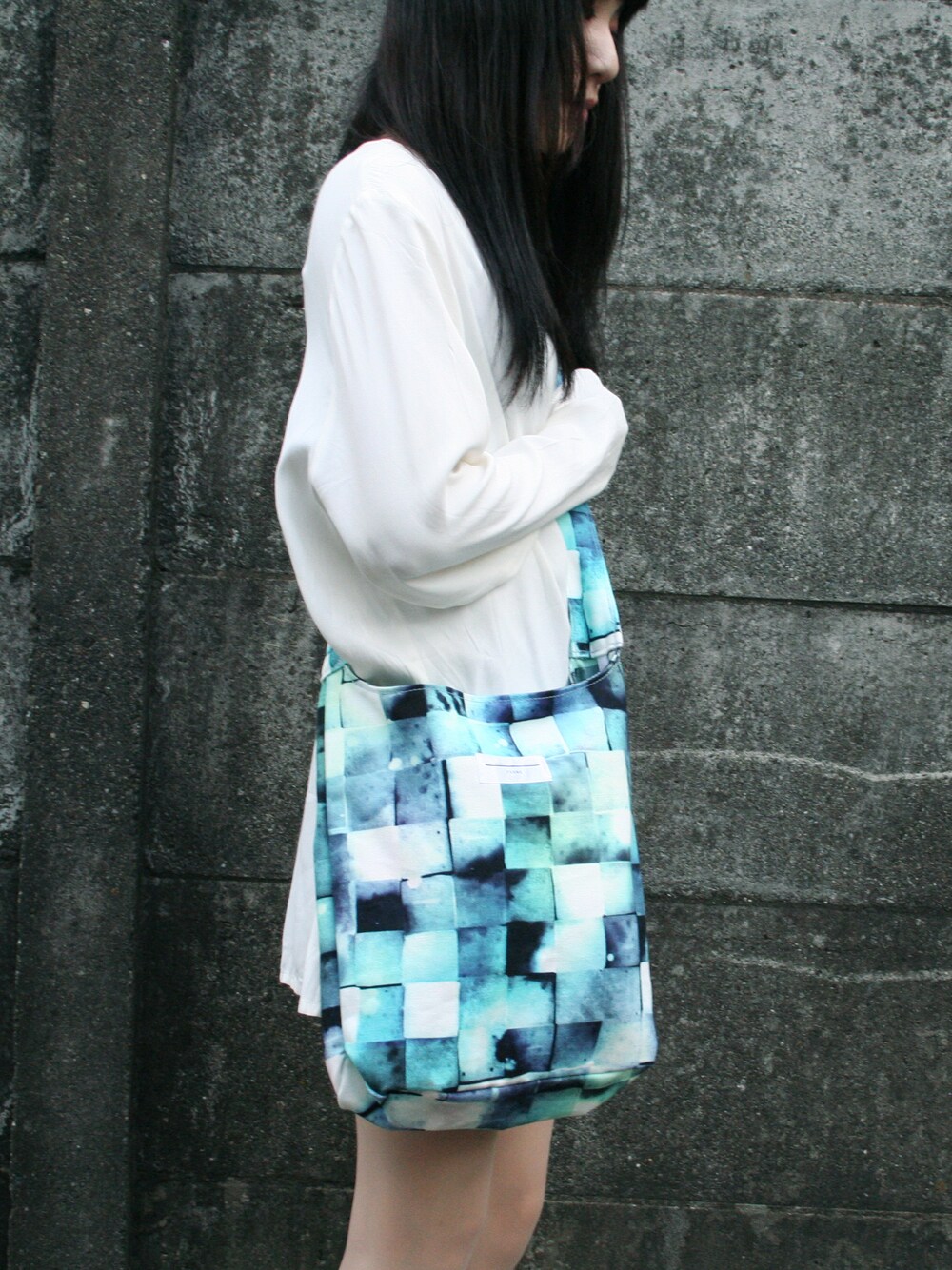 ブルー系のショルダーバッグを着用したレディースの秋コーディネートの1枚目の写真