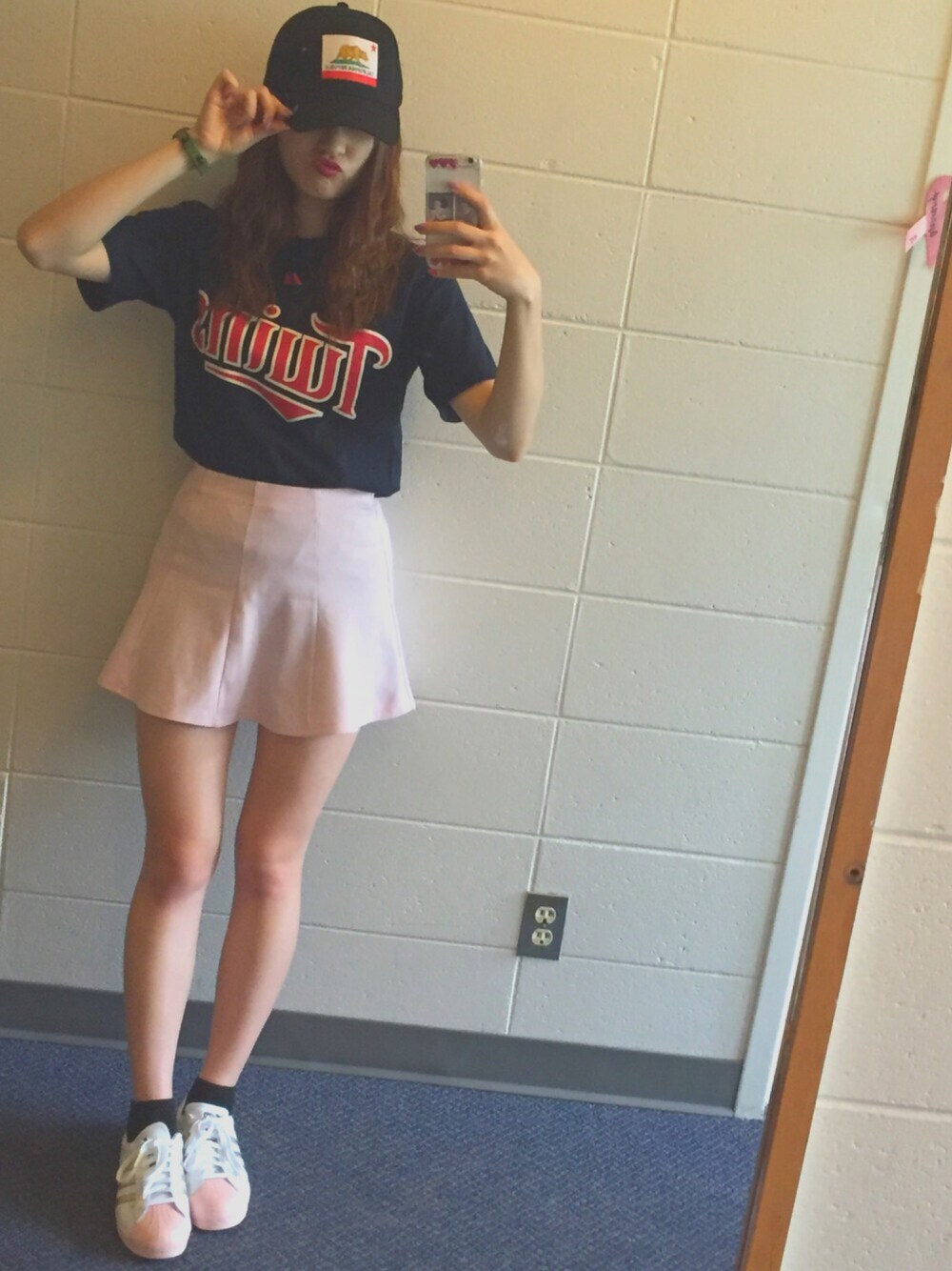 ピンク系のスカート、その他のTシャツ/カットソー、ホワイト系のスニーカーを着用したレディースの春コーディネートの1枚目の写真