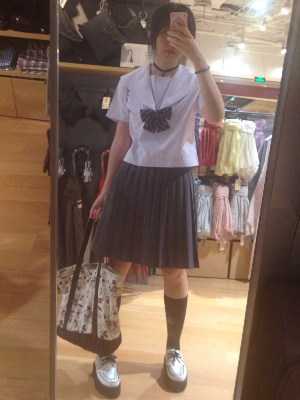 ホワイト系のシューズ、ブルー系の蝶ネクタイ、グレー系のスカートを着用したレディースの秋コーディネートの1枚目の写真