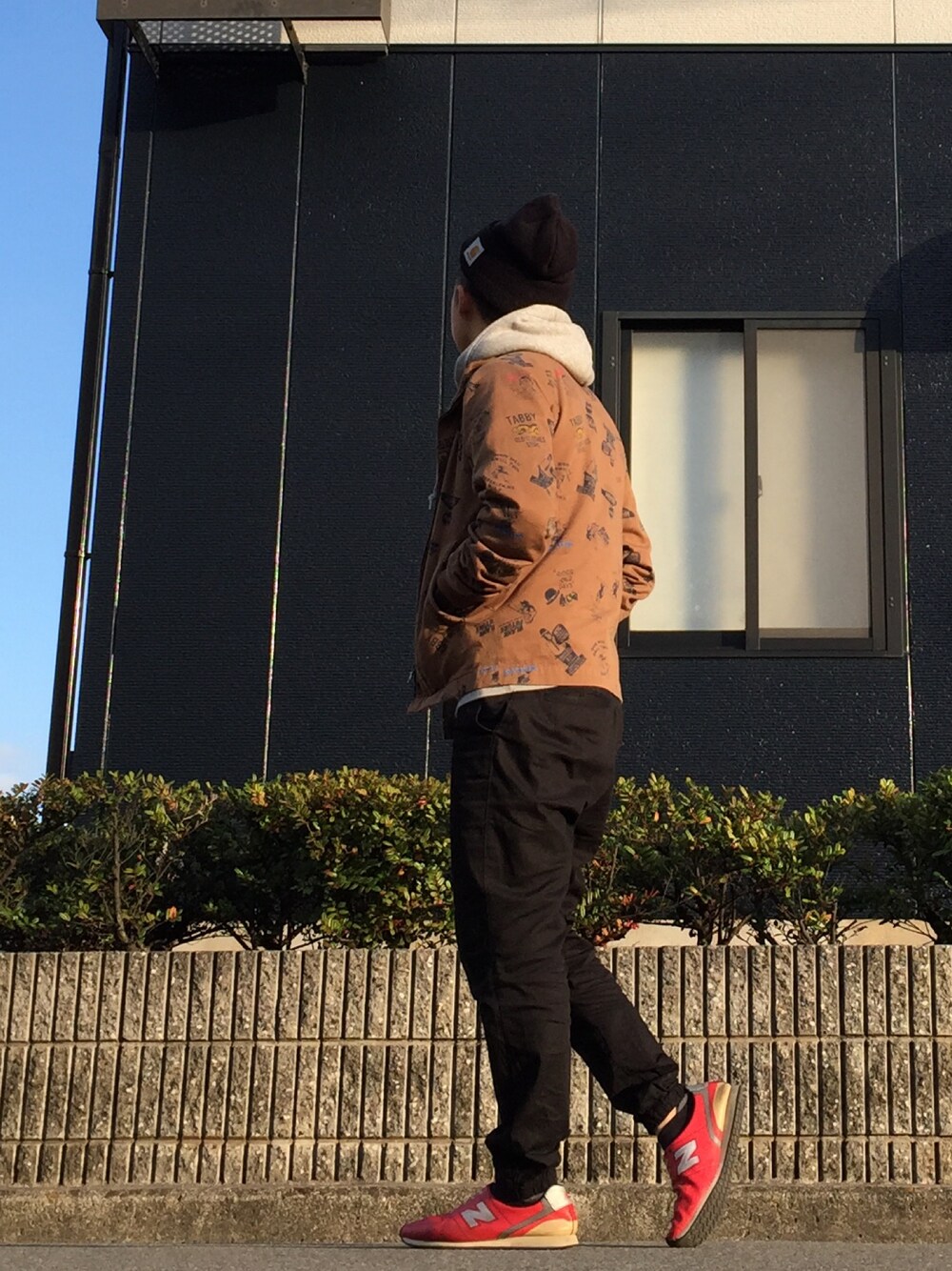 ブラウン系のスタジャン、ブラック系のその他パンツ、グレー系のパーカーを着用したメンズの冬コーディネートの1枚目の写真