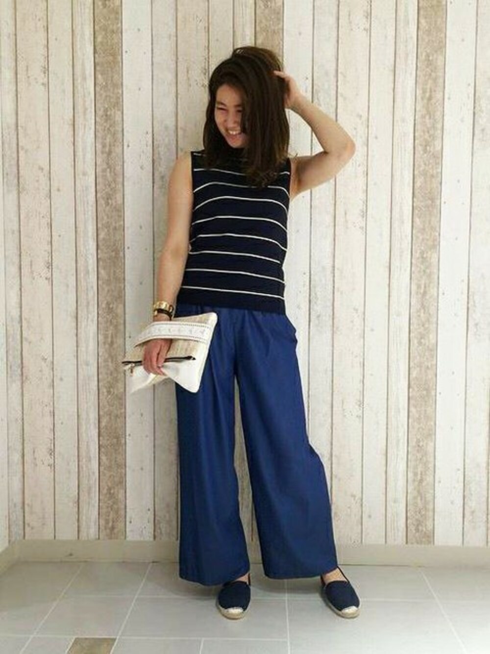 ブルー系のニット/セーター、ブルー系のモカシン/デッキシューズを着用したレディースの春コーディネートの1枚目の写真