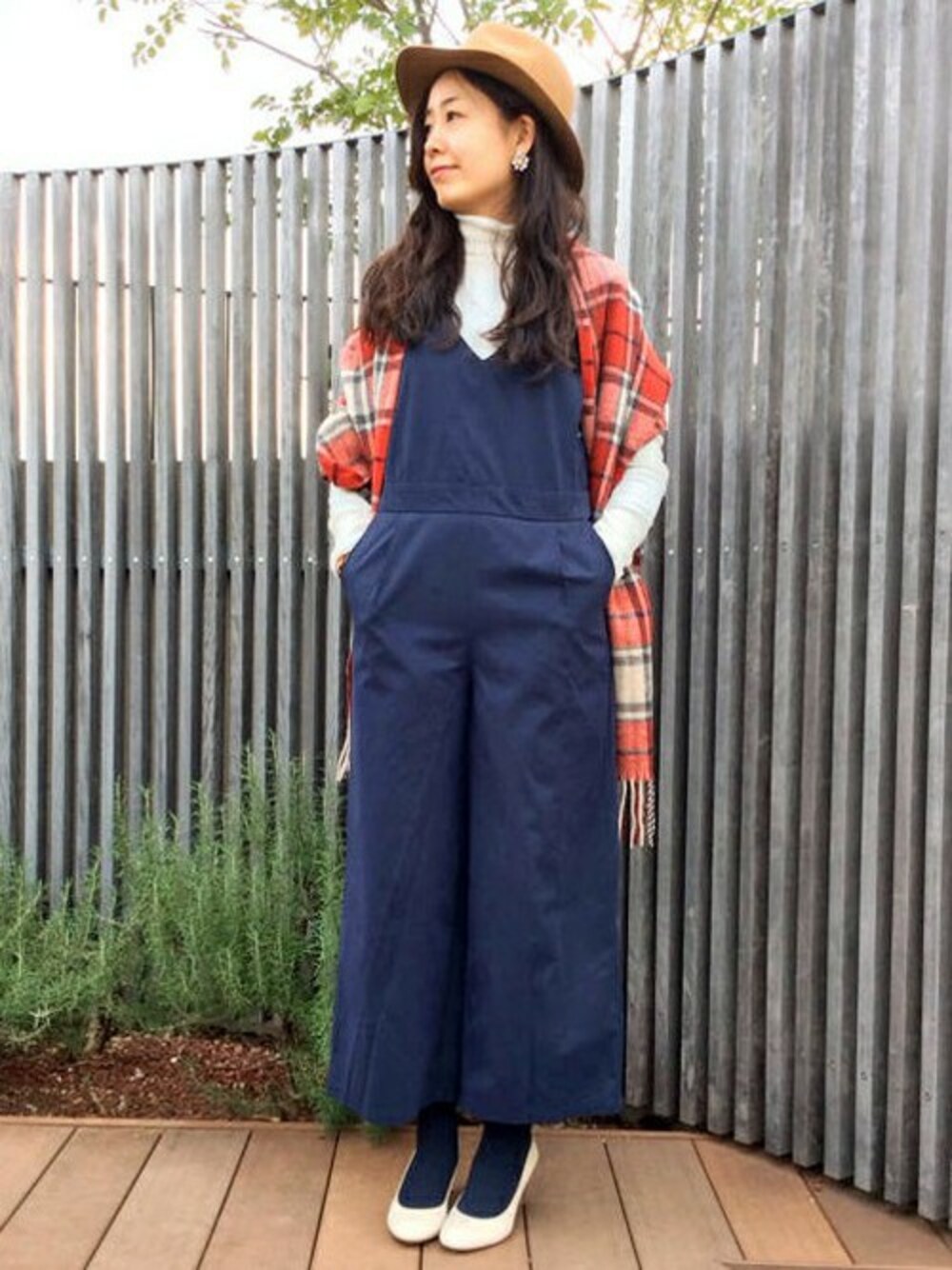 ホワイト系のニット/セーター、ブルー系のサロペット/オーバーオール、ブラウン系のハットを着用したレディースの冬コーディネートの1枚目の写真