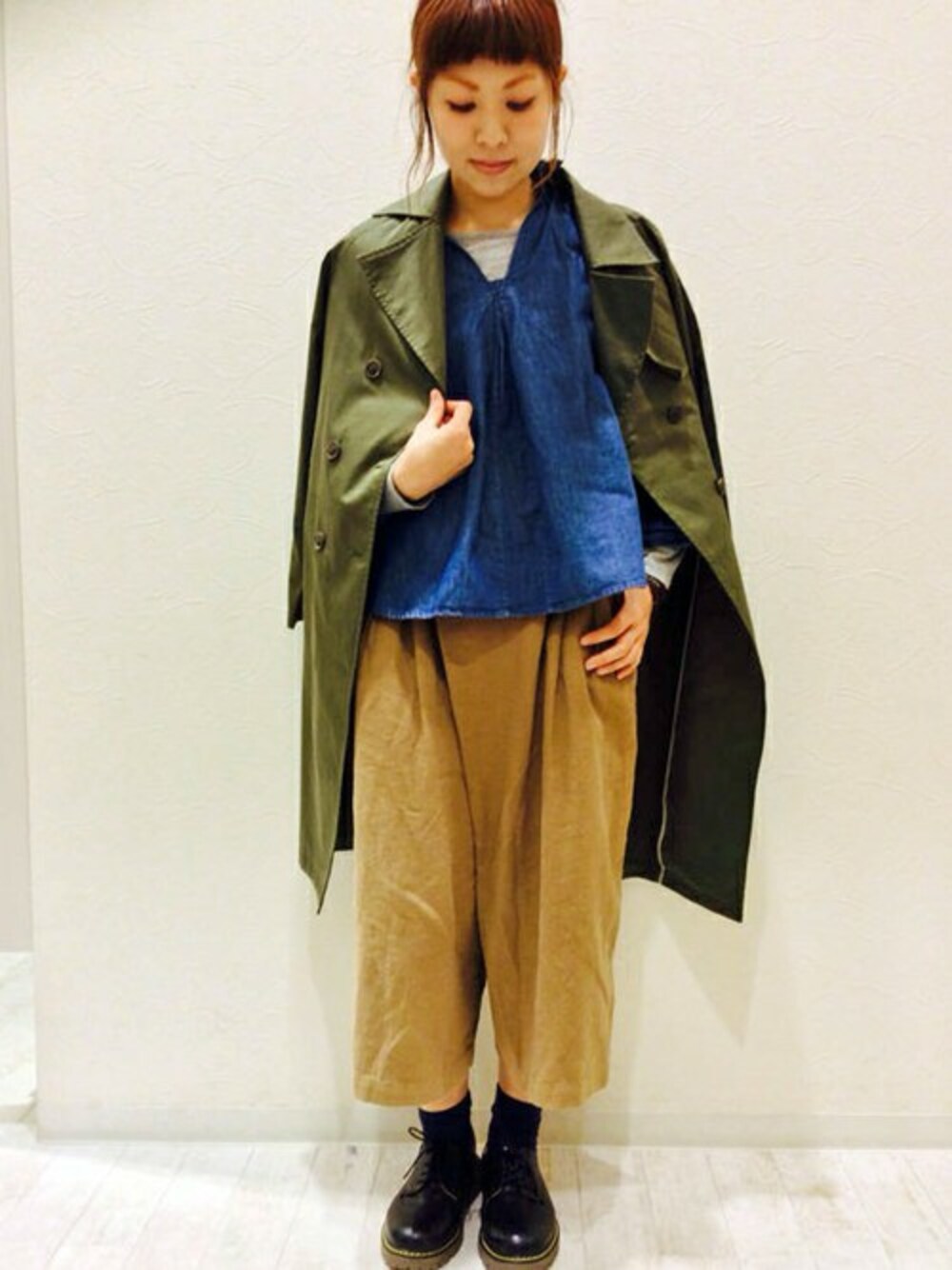 ブラウン系のその他パンツ、グリーン系のトレンチコート、ブルー系のシャツ/ブラウスを着用したレディースの春コーディネートの1枚目の写真