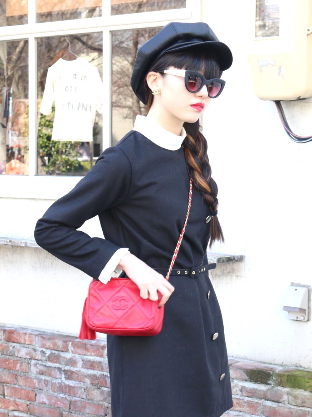 レッド系のショルダーバッグを着用したレディースの冬コーディネートの1枚目の写真