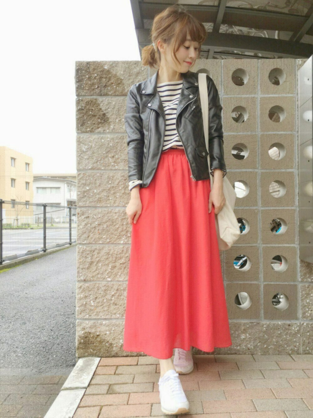 レッド系のスカート、ブラック系のライダースジャケット、ホワイト系のTシャツ/カットソーを着用したレディースの春コーディネートの1枚目の写真
