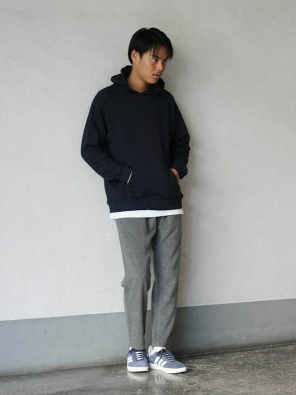 ブラック系のパーカー、グレー系のその他パンツ、ブルー系のスニーカーを着用したメンズの秋コーディネートの1枚目の写真