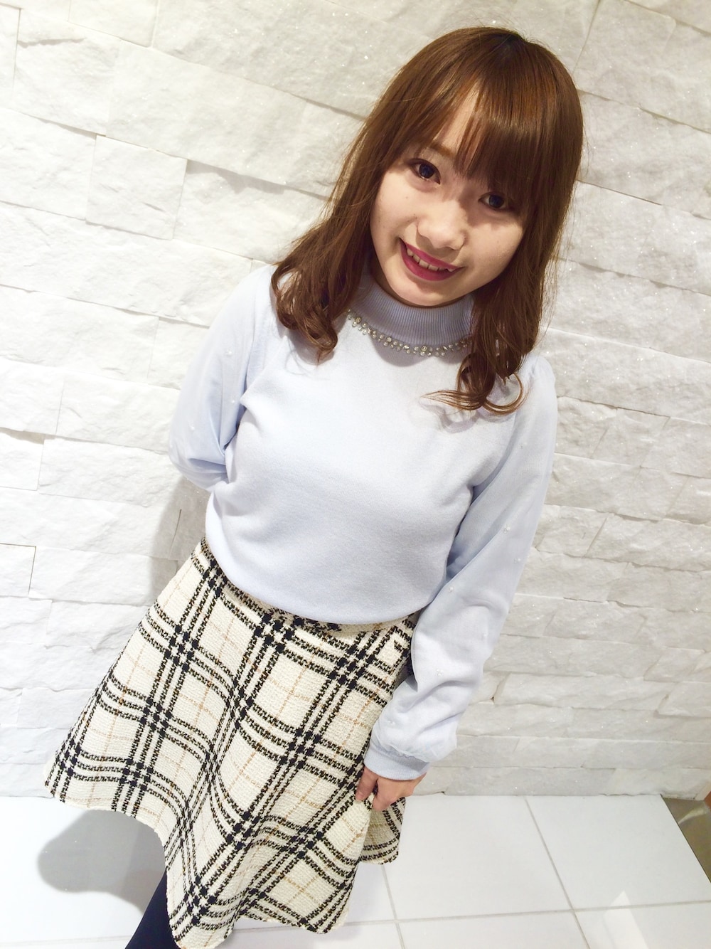ブルー系のニット/セーター、ホワイト系のスカートを着用したレディースの秋コーディネートの1枚目の写真