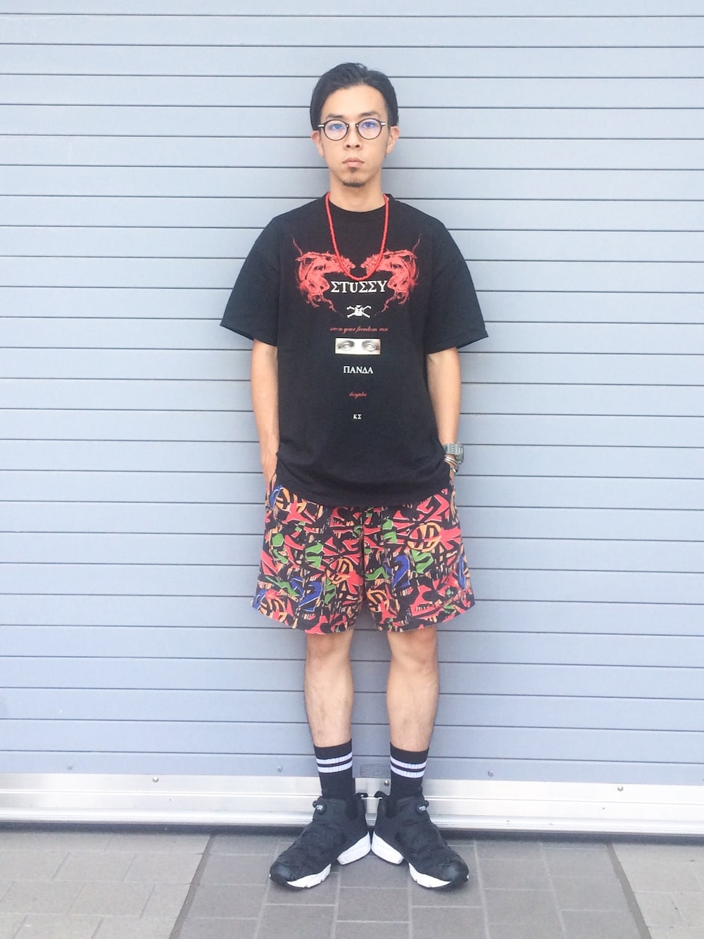 「ネックレス、ブラック、men、ポンプフューリー、ハーフパンツ、ラインソックス、メガネ男子、ストリート、Tシャツ、ビーズネックレス」｜「STUSSYのアイテム（Tシャツ/カットソー、ブラック系）」を使った、Ken Matsudaさん（メンズ・174cm）の夏コーディネートの1枚目の写真