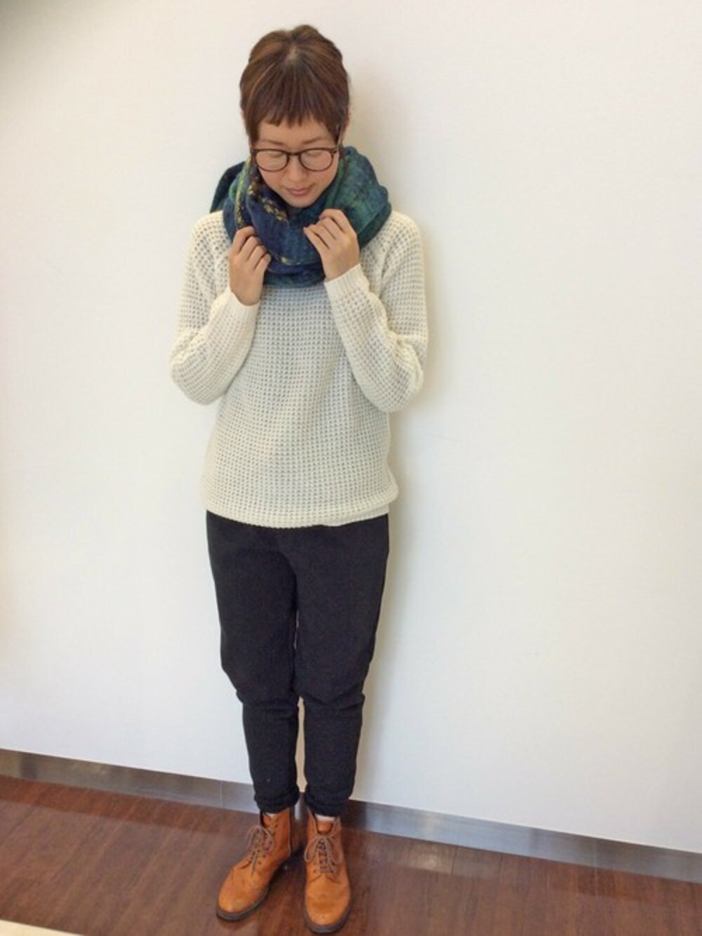 ブラック系のその他パンツ、ホワイト系のニット/セーター、グリーン系のマフラーを着用したレディースの冬コーディネートの1枚目の写真