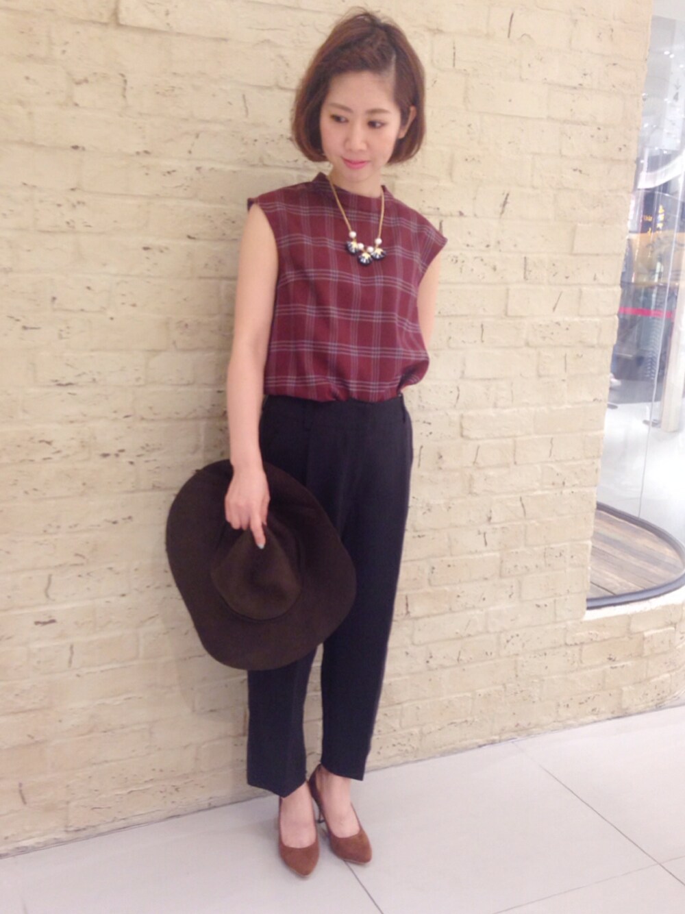 ブラック系のその他パンツ、ベージュ系のパンプス、ブルー系のネックレスを着用したレディースの夏コーディネートの1枚目の写真