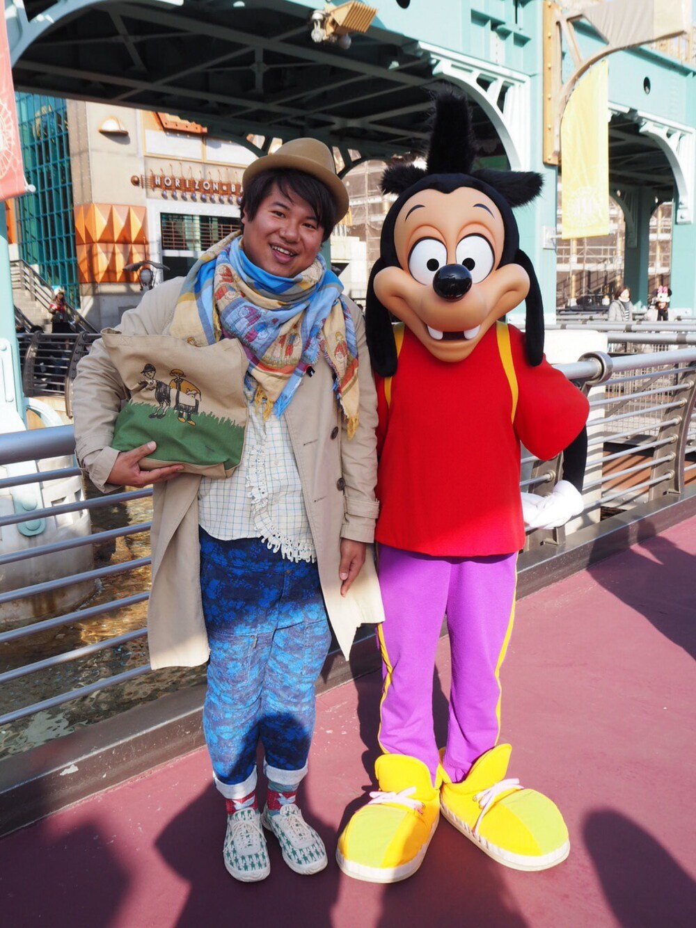 ブラウン系のトートバッグ、ホワイト系のスニーカー、ブルー系のその他パンツを着用したメンズの冬コーディネートの1枚目の写真