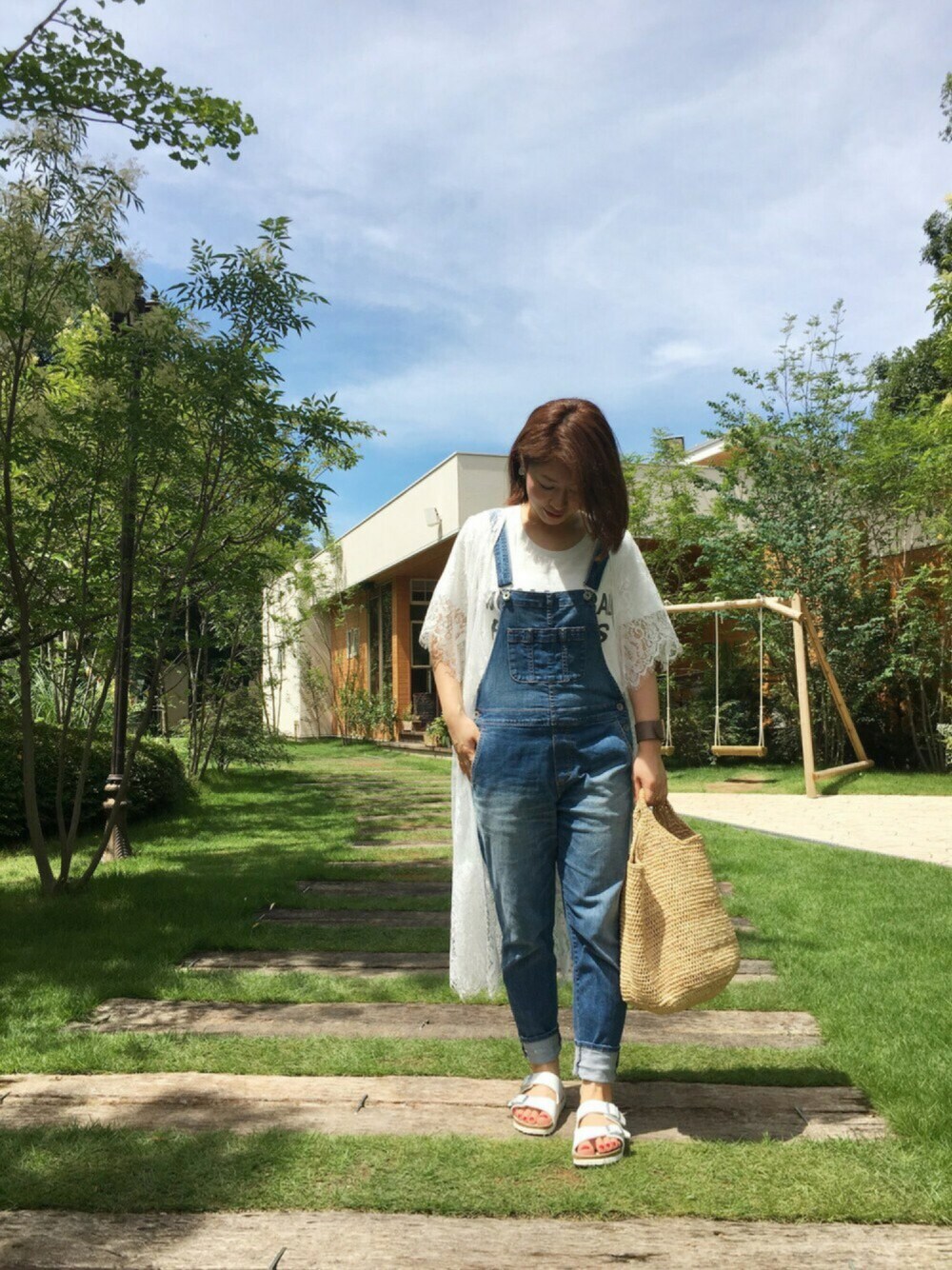 ホワイト系のカーディガン/ボレロ、ベージュ系のかごバッグ、ホワイト系のTシャツ/カットソーを着用したレディースの夏コーディネートの1枚目の写真