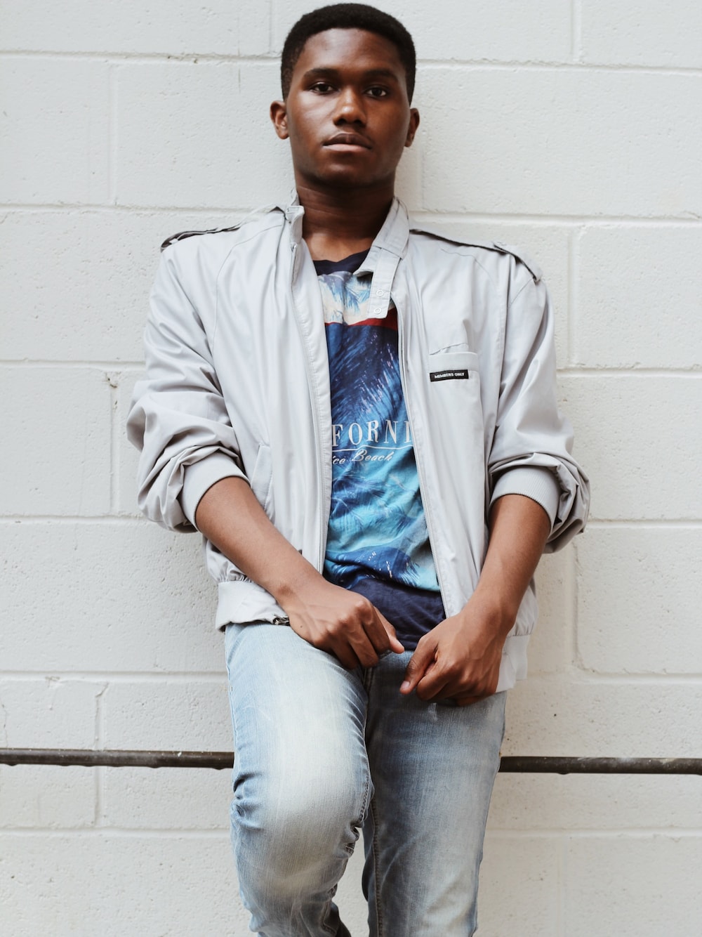 ブルー系のTシャツ/カットソー、シルバー系のナイロンジャケット、ブルー系のデニムパンツを着用したメンズの冬コーディネートの1枚目の写真