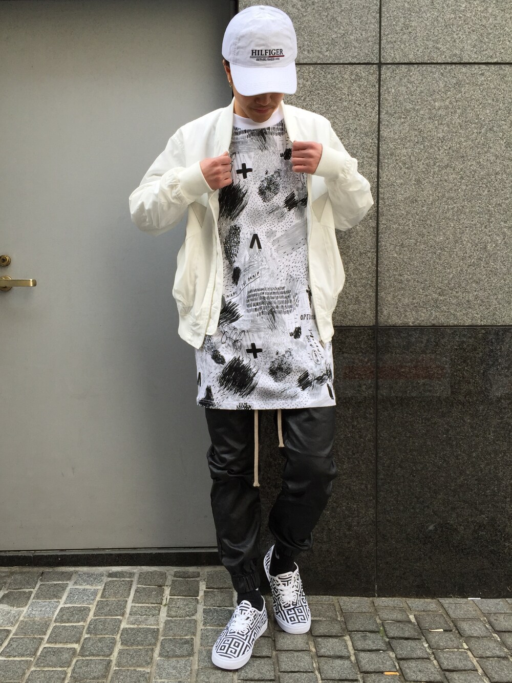 ホワイト系のミリタリージャケット、ホワイト系のTシャツ/カットソー、ブラック系のその他パンツを着用したメンズの春コーディネートの1枚目の写真