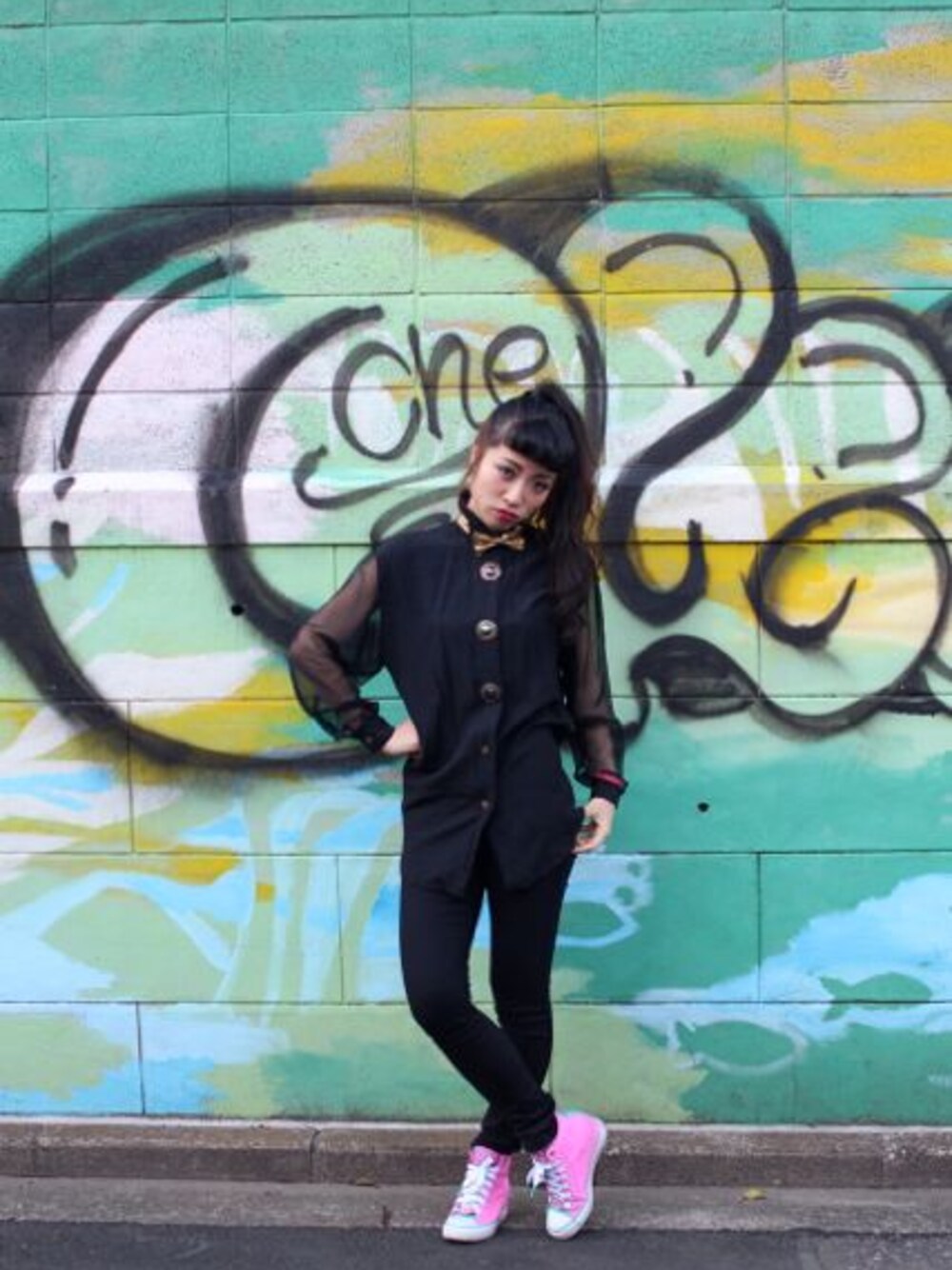 ゴールド系の蝶ネクタイ、ピンク系のスニーカーを着用したレディースの春コーディネートの1枚目の写真