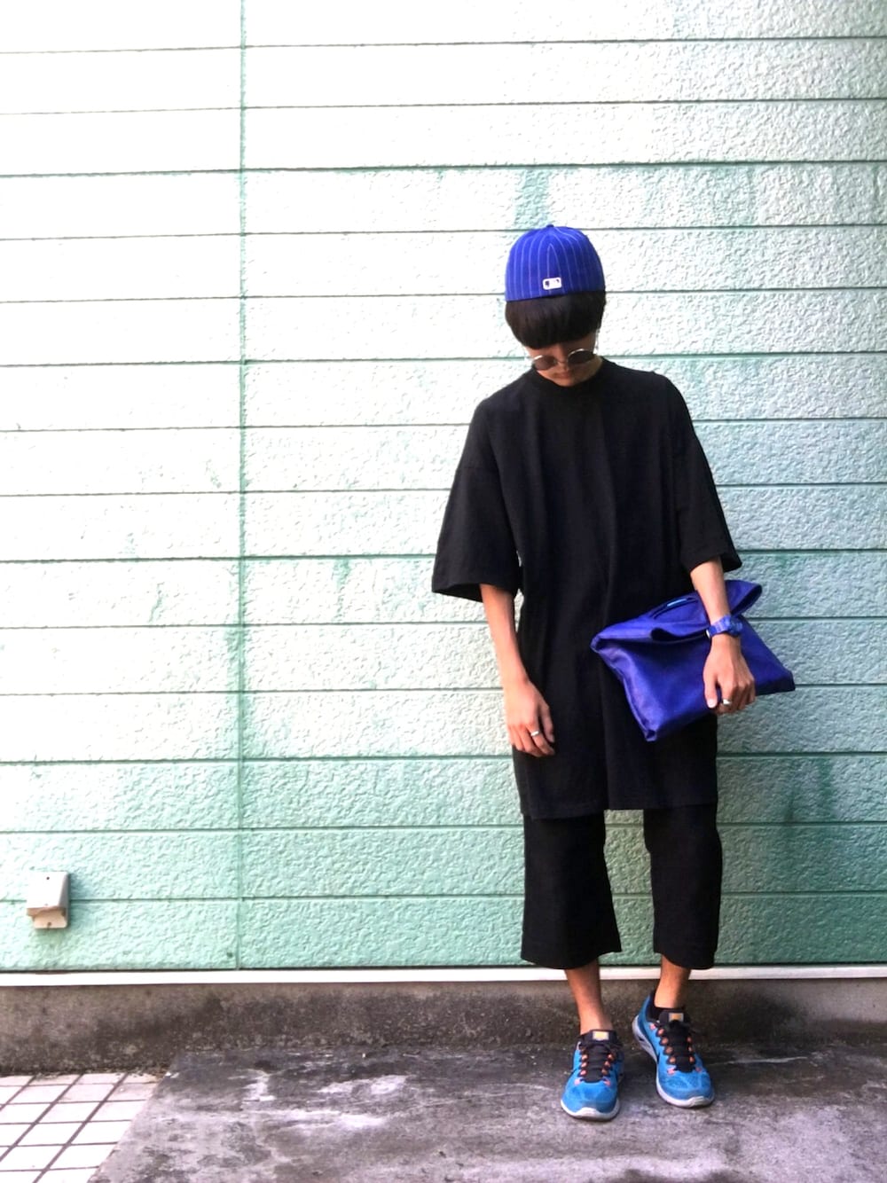 ブラック系のTシャツ/カットソー、ブルー系のクラッチバッグ、ブラック系のその他パンツを着用したメンズの夏コーディネートの1枚目の写真