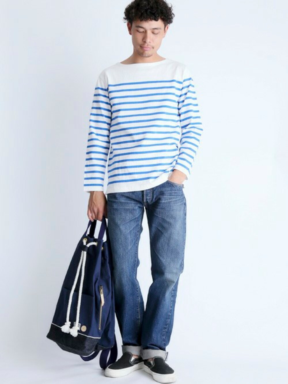 ブルー系のデニムパンツ、その他のTシャツ/カットソー、ブルー系のバックパック/リュックを着用したメンズの冬コーディネートの1枚目の写真