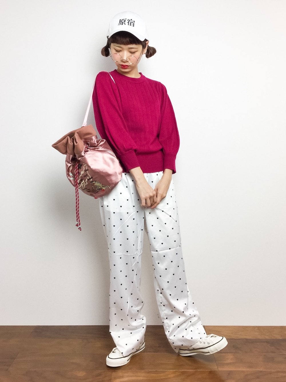 ピンク系のニット/セーター、ホワイト系のその他パンツ、ピンク系のバックパック/リュックを着用したレディースの秋コーディネートの1枚目の写真