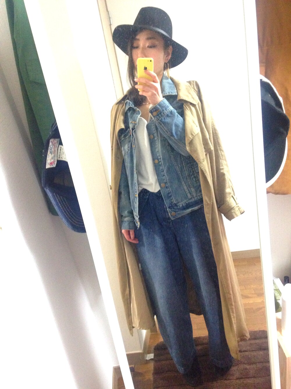 イエロー系のトレンチコート、ブルー系のデニムジャケット、ホワイト系のTシャツ/カットソーを着用したレディースの春コーディネートの1枚目の写真