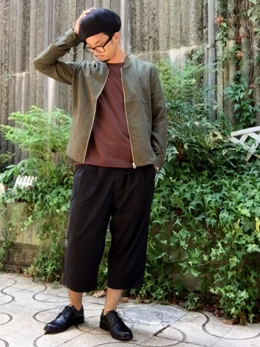グリーン系のトップス、ブラック系のシューズ、ブラウン系のTシャツ/カットソーを着用したメンズの夏コーディネートの1枚目の写真