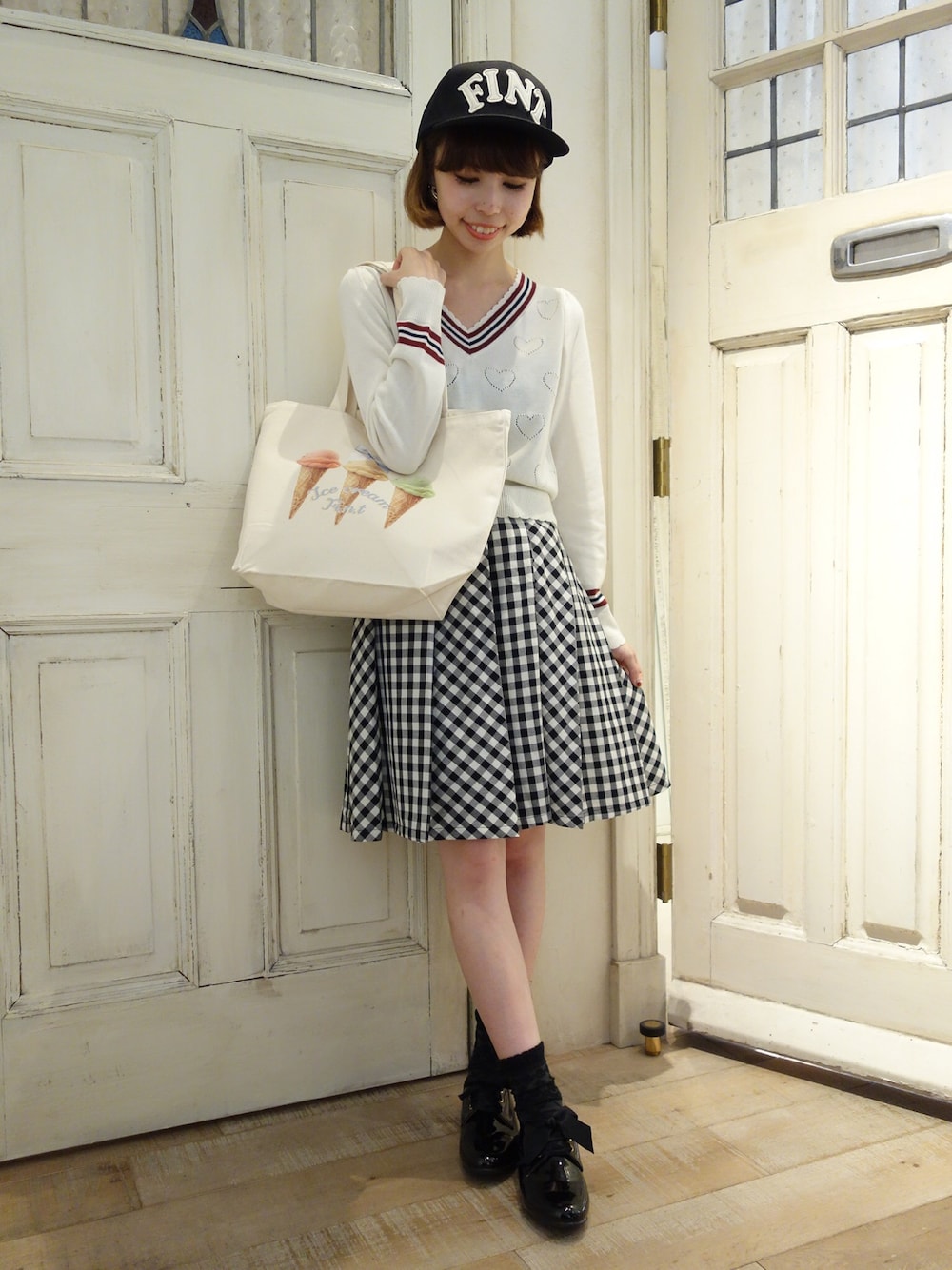 ブラック系のスカートを着用したレディースの秋コーディネートの1枚目の写真