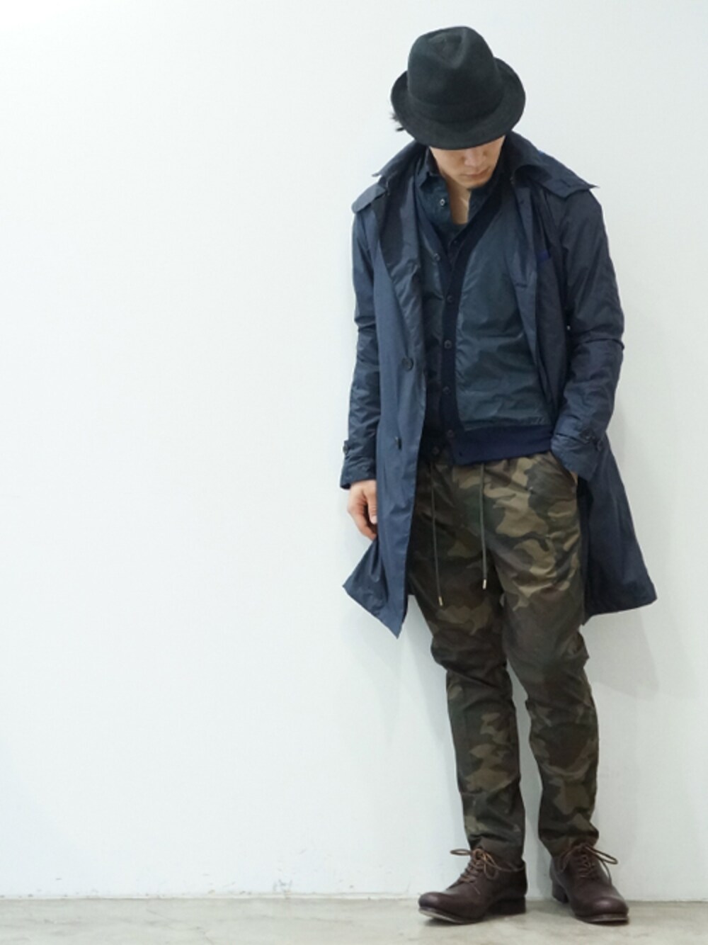 ブルー系のステンカラーコートを着用したメンズの春コーディネートの1枚目の写真