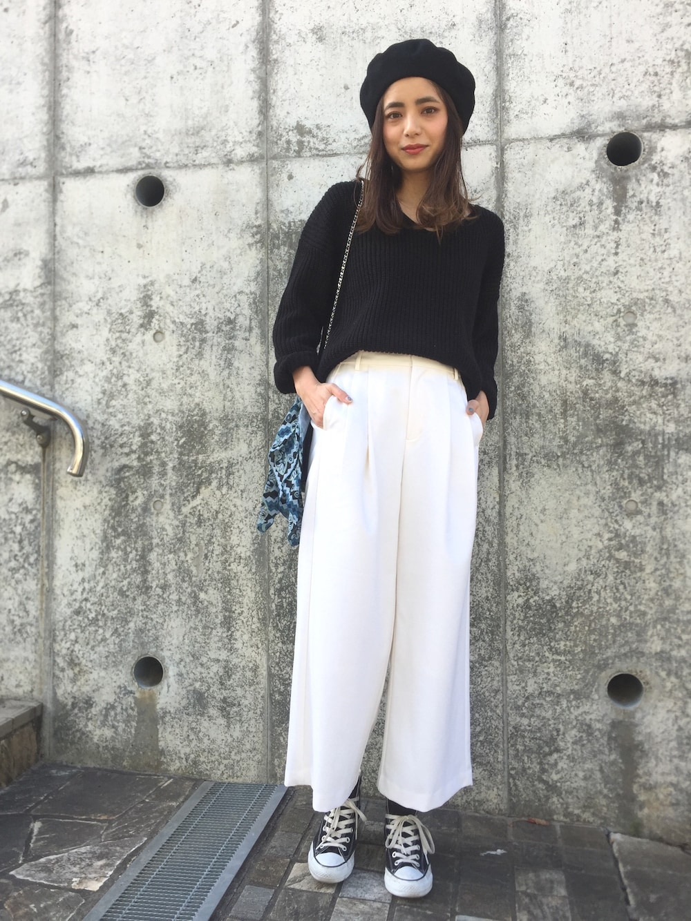 ホワイト系のその他パンツ、ブラック系のニット/セーター、ブラック系のスニーカーを着用したレディースの春コーディネートの1枚目の写真