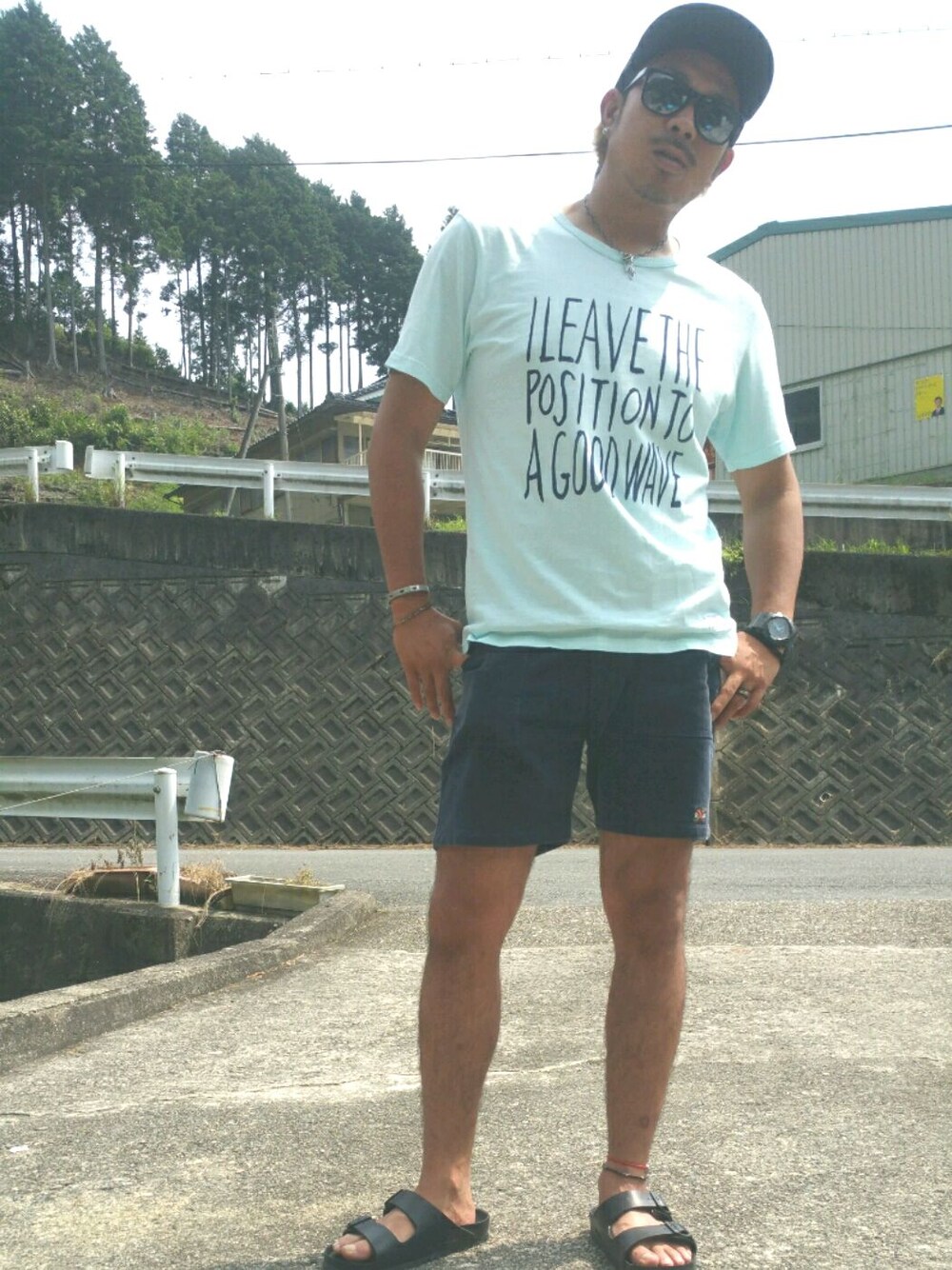 ブラック系のサンダル、ブルー系のその他パンツ、グリーン系のTシャツ/カットソーを着用したメンズの夏コーディネートの1枚目の写真
