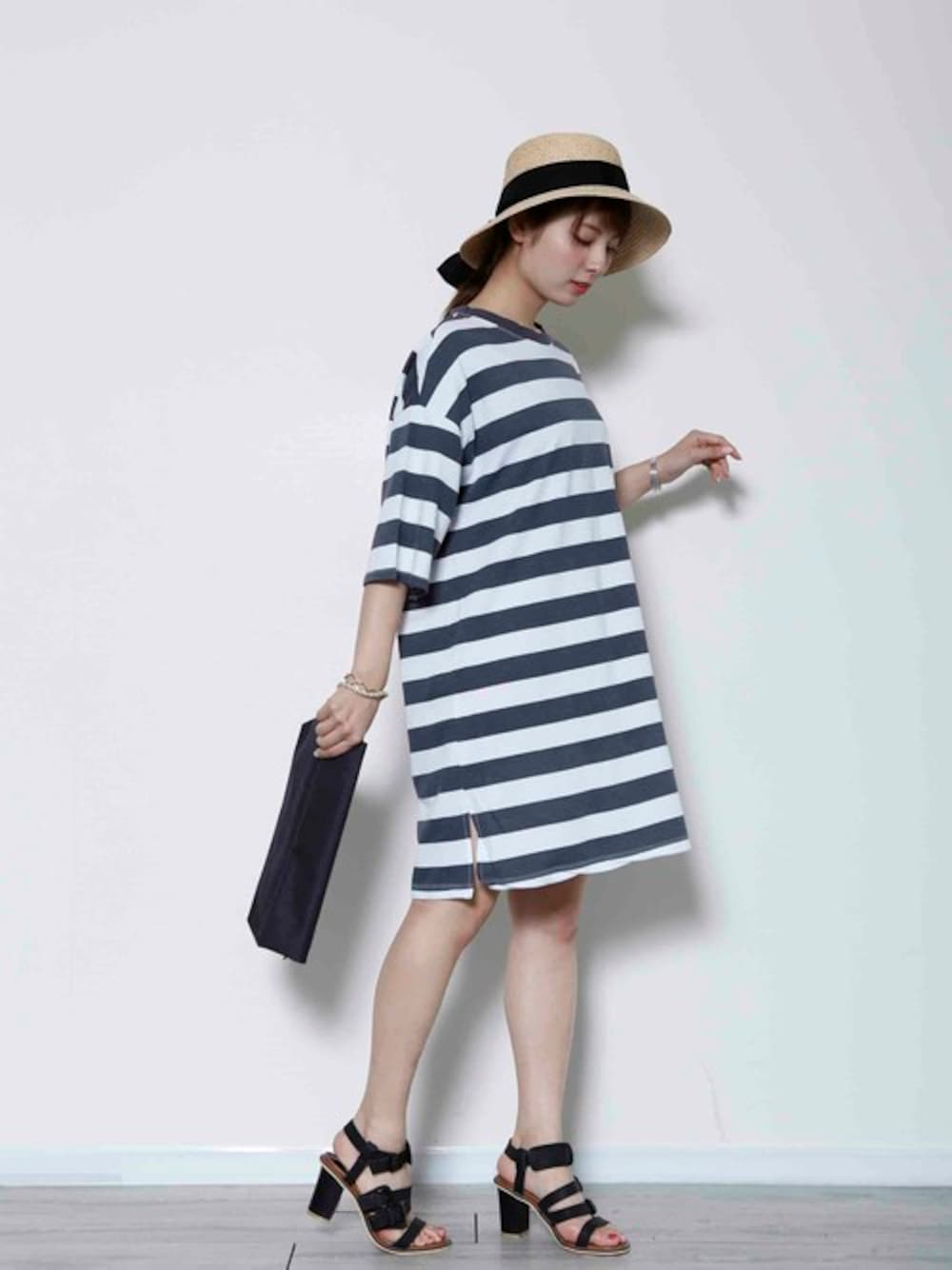 ブラック系のTシャツ/カットソー、ブラック系のサンダル、ブラック系のクラッチバッグを着用したレディースの夏コーディネートの1枚目の写真