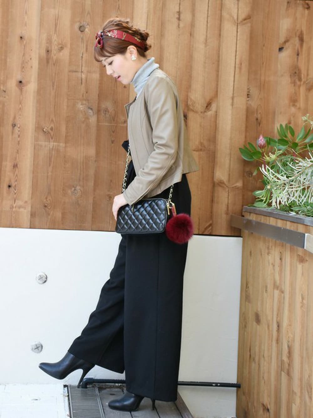 ブラック系のショルダーバッグ、レッド系のチャームを着用したレディースの冬コーディネートの1枚目の写真