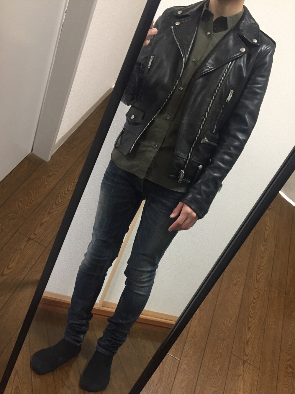 ブルー系のデニムパンツ、ブラック系のライダースジャケット、グリーン系のシャツ/ブラウスを着用したメンズの秋コーディネートの1枚目の写真