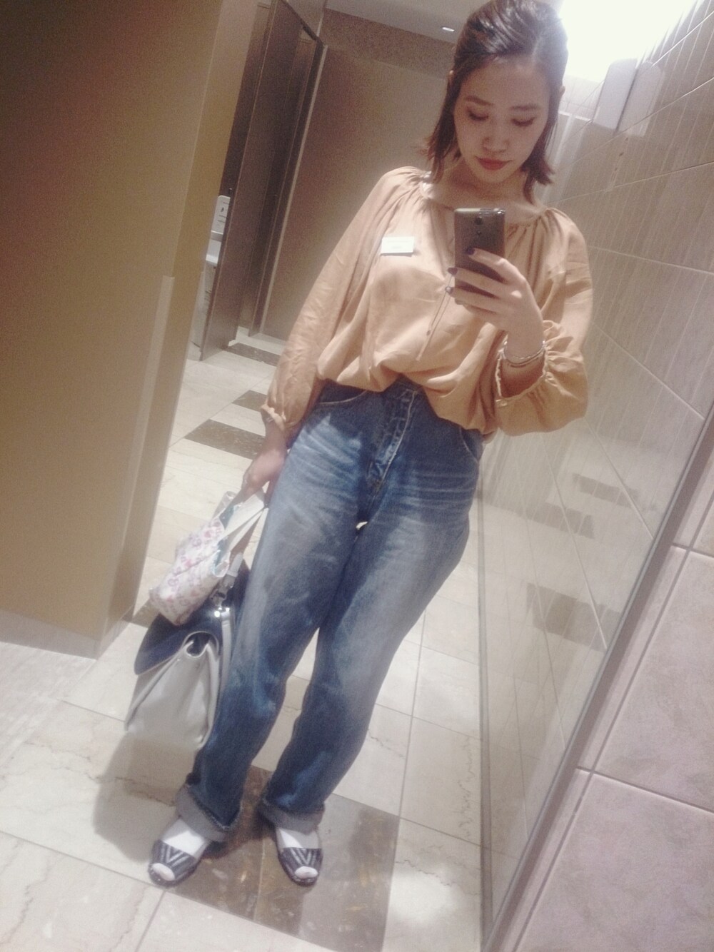 ベージュ系のシャツ/ブラウス、ブラック系のサンダルを着用したレディースの春コーディネートの1枚目の写真