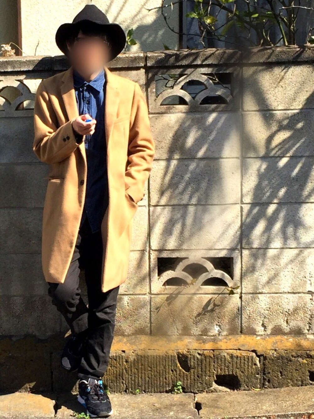 ベージュ系のチェスターコート、ブラック系のその他パンツを着用したメンズの冬コーディネートの1枚目の写真