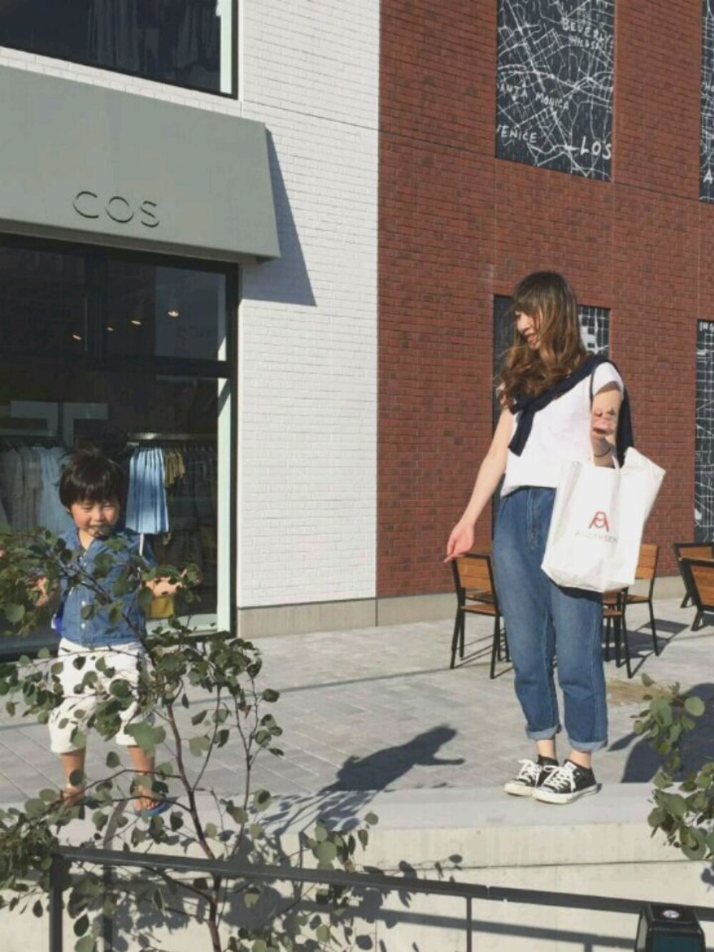 ブルー系のデニムパンツ、ブラック系のスニーカー、ホワイト系のTシャツ/カットソーを着用したキッズの秋コーディネートの1枚目の写真